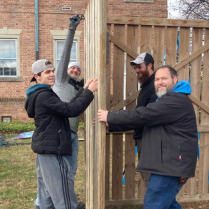 men working at fence
